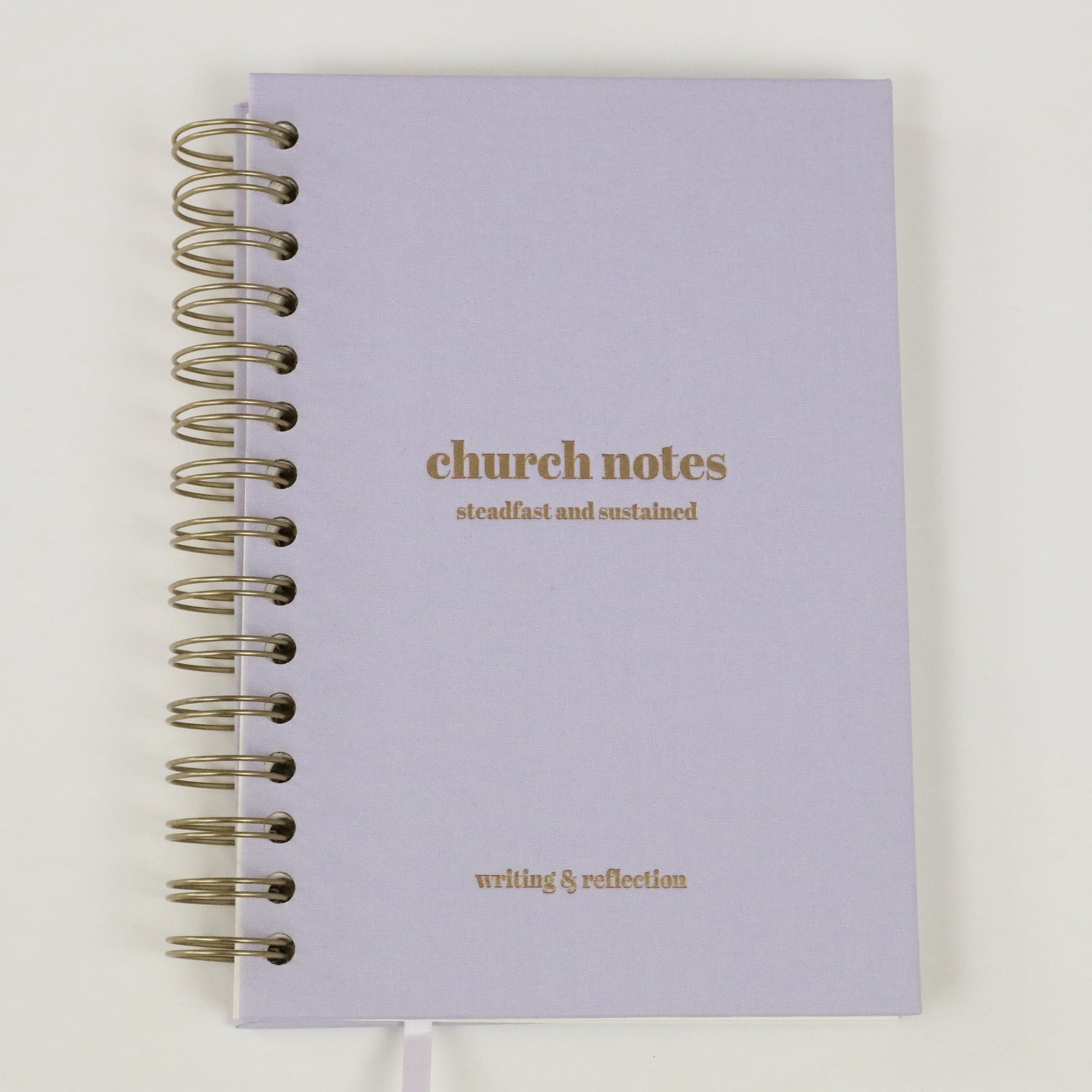 Purple linen church notes notebook with gold text on a white background