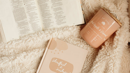 Open Bible and Steadfast and Sustained Bible Notes journal with a candle for cozy quiet time