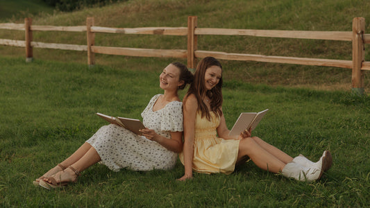Two friends journaling Scripture together with Steadfast and Sustained journals