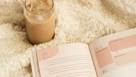 Cozy prayer journaling with a Steadfast and Sustained journal and iced coffee