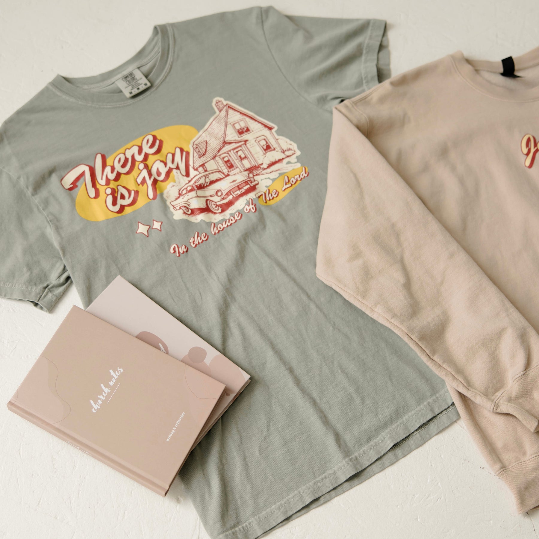 Light green Christian t-shirt with a vintage graphic, stating "there is joy in the house of the Lord" with a picture of a house and vintage car