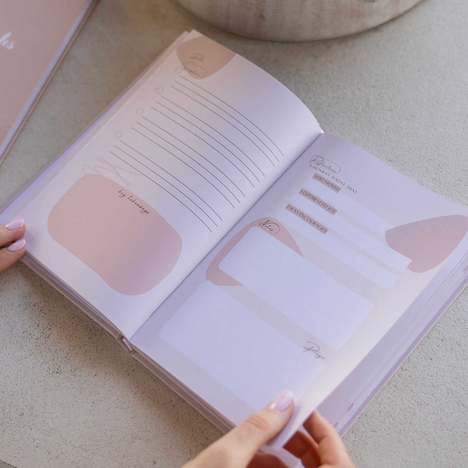 Open Bible study journal showing guided reflection pages with space for notes, prayer, and key takeaways